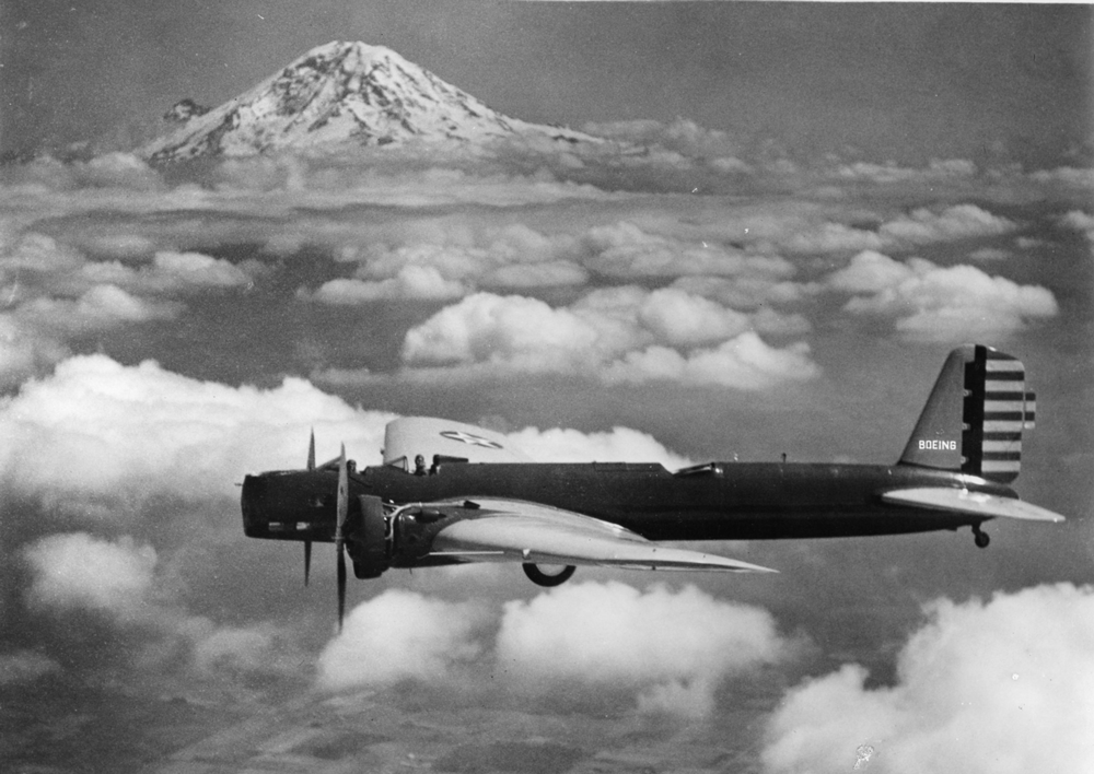 Boeing plane flying in front of Mount Rainier backdrop